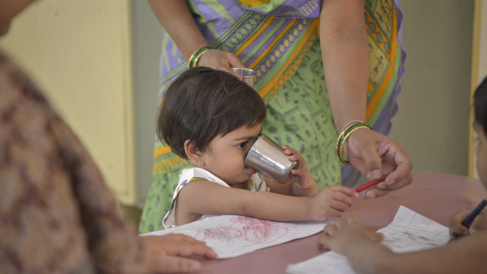 Small child drinking from cup