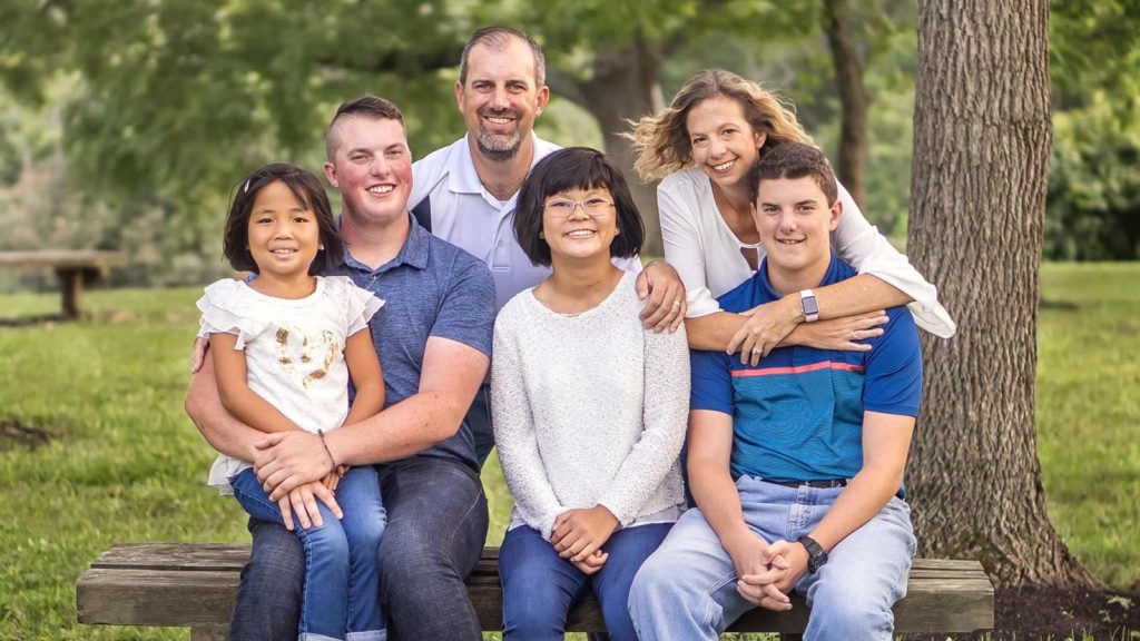 adoptive family smiling for a portrait