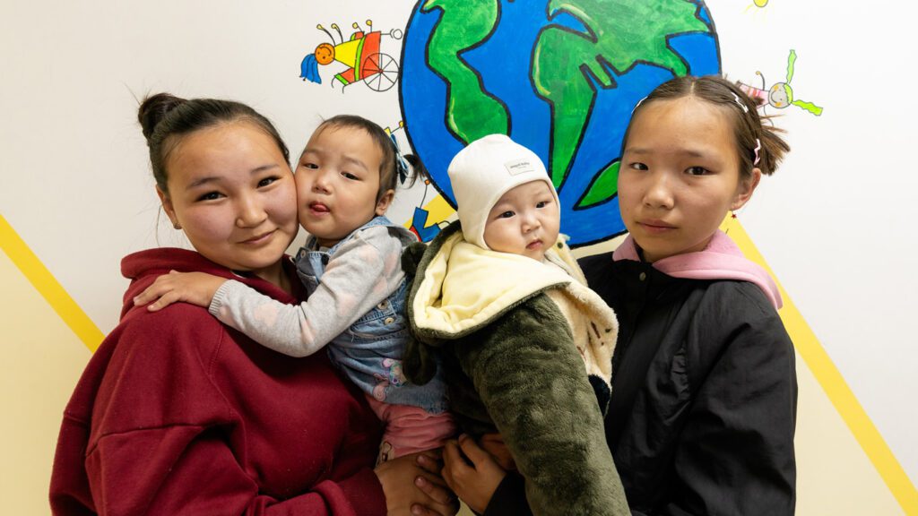 A mom with her two children and sister at the Joyful Palace