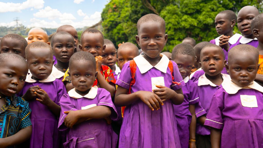 School kids in Uganda wearing purple uniforms
