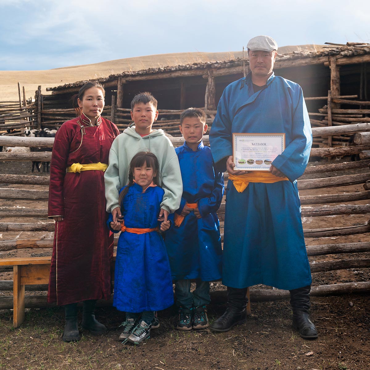 A nomadic herding family in Mongolia wear traditional dress