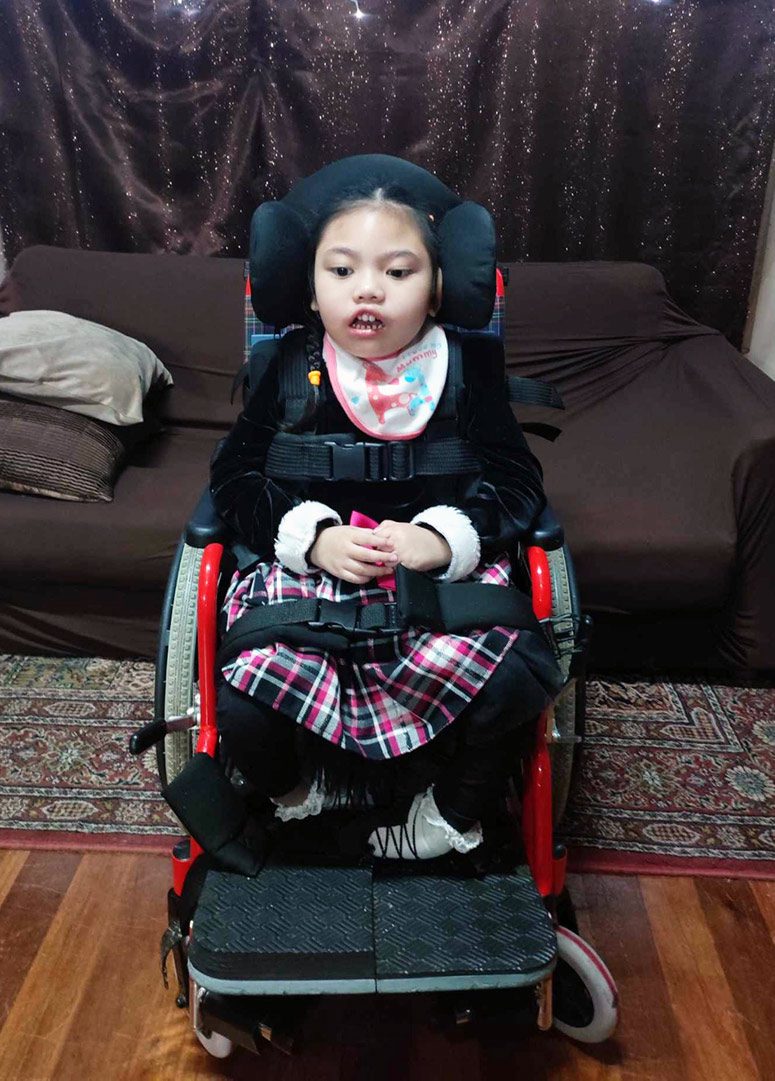 A girl sits in a wheelchair