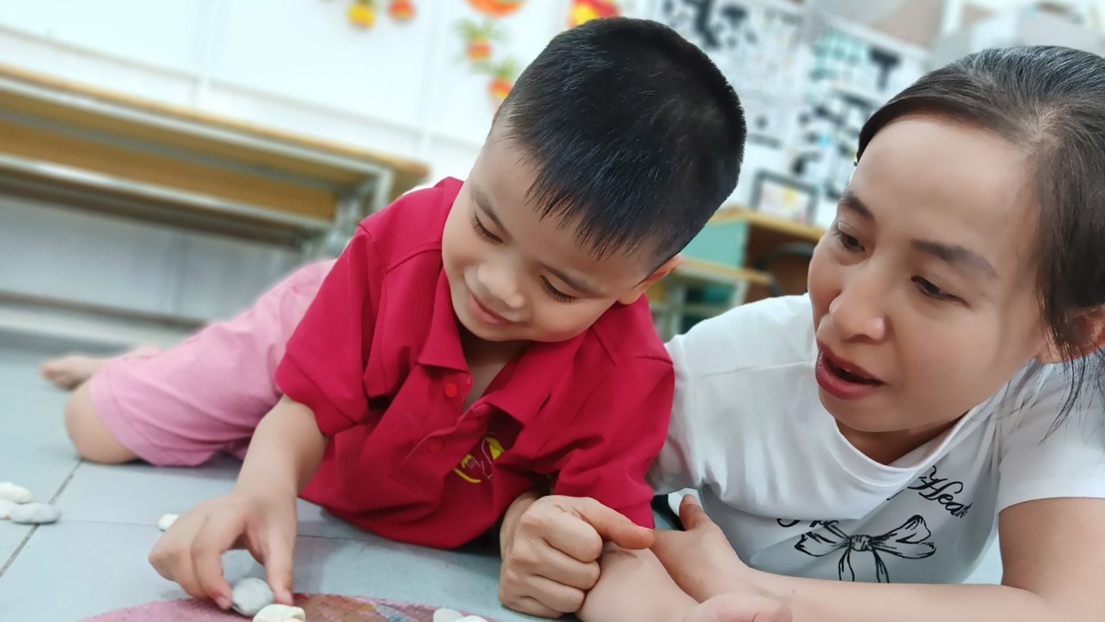 Boy with autism and teacher at Kianh Foundation in Vietnam