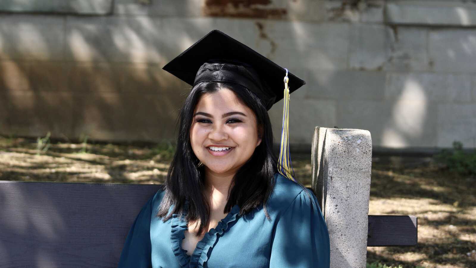 Holt adoptee graduate in cap and gown