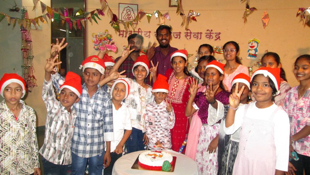 Children in holiday hats celebrate Christmas at BSSK party, Holt-supported programs worldwide