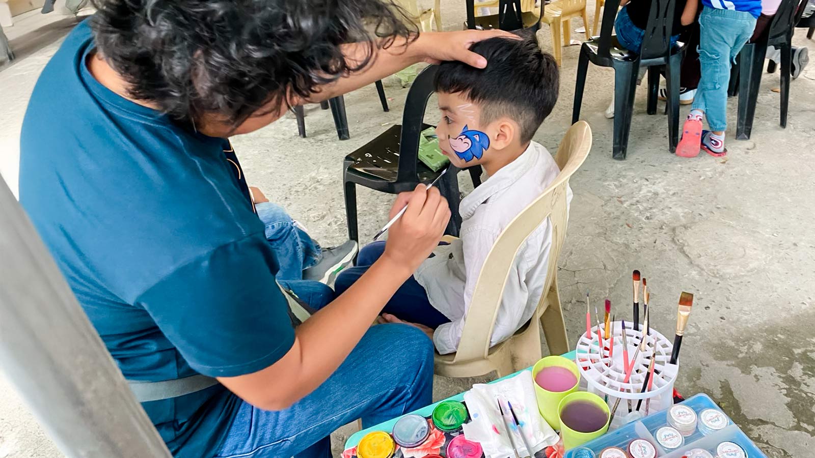 a child in the Philippines has his face painted for a Christmas celebration