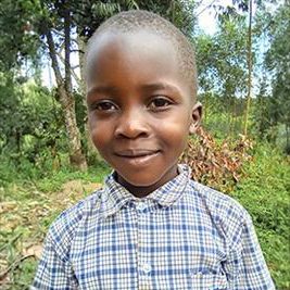 A sponsored child in Uganda smiles outdoors